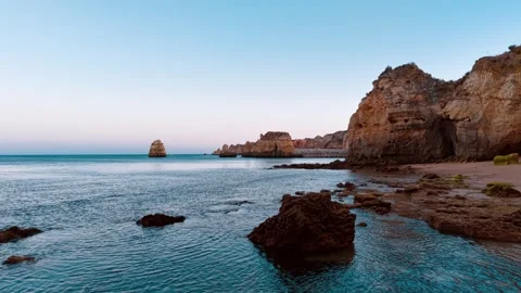 Coastal cliffs and tranquil waters of Portugal at dusk Stock Footage 312326283
