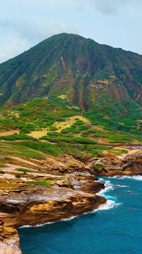Coastal cliffs with green mountain and layered terrain. Vertical video. Stock Footage 319760116