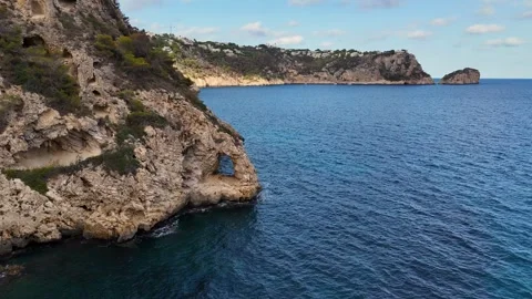 Coastal cliffs rock formations cave Javea Mediterranean seascape aerial 動画素材 336643345