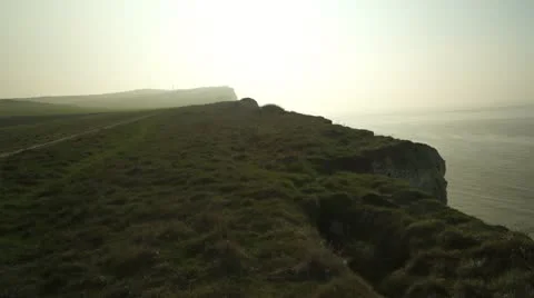 Coastal cliffs at sunset, seagulls flying over Stock Footage 10843887