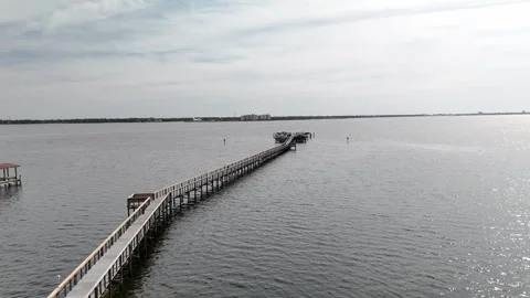 Coastal condos with pool and palm trees with overlooking a bay and dock, Panama Stock Footage 309848032