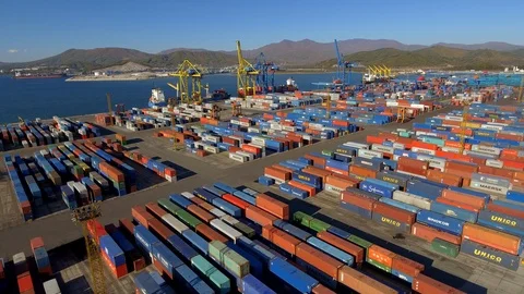 Coastal Container terminal port multi-colored cargo containers Logistics Aerial Stock Footage 98829341