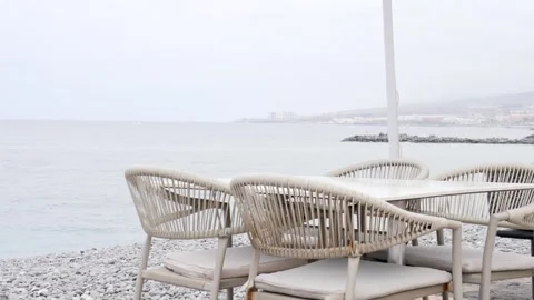 Coastal Dining Experience with Elegant Rattan Furniture Stock Footage 316666813