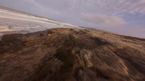 Coastal drone footage captures dramatic ocean waves hitting rocky shore Stock Footage 344679303