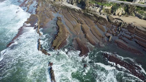 Coastal Drone View of Beach with Cliffside Houses and Ocean Waves Stock Footage 312753913