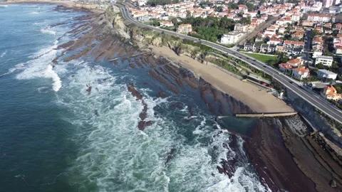 Coastal Drone View of Beach with Cliffside Houses and Ocean Waves Stock Footage 312753935