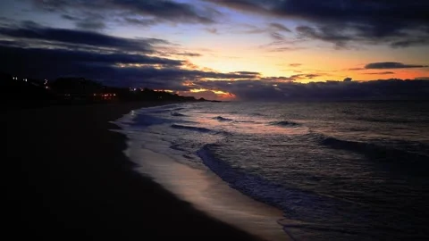 Coastal Dusk Waves: Beach Scene with Distant Lights Stock-Footage 309914529