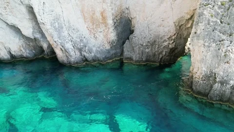 Coastal Elegance: 4K Drone Capture of Boat Sailing Through Cliff Crevice Stock Footage 250029926