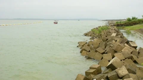 Coastal Erosion Control Blocks and Dredging Pipe in Tidal Rive Stock Footage 320521761
