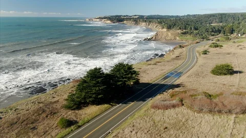 Coastal highway winds along cliffs, ocean waves crash below. Point Arena, USA Video stock 101718637