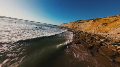 Coastal landscape with rugged cliffs, sandy shores, and lively ocean waves Stock Footage 339786959