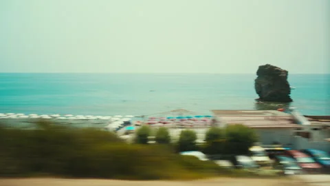 Coastal landscape with a sea stack at Fuscaldo, seen from the train in summer Stock Footage 340275277