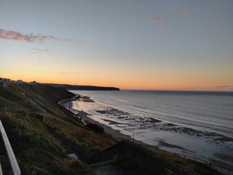 Coastal landscape at sunset with dramatic cliffs Stock Photos