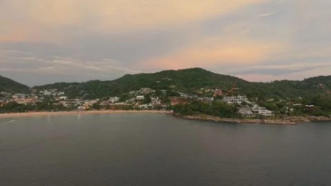 Coastal landscape view of beach and hillside with sunset colors in sky Stock-Footage 342332185