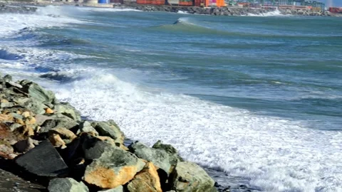 Coastal landscape with waves and container port of Genoa Voltri in the backg Stock Footage 293352722