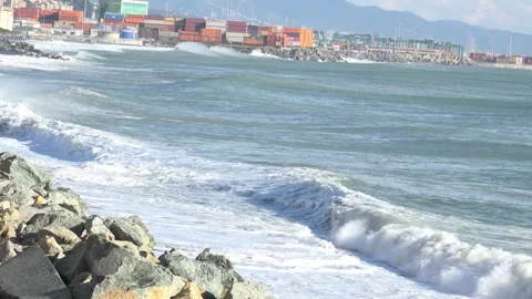 Coastal landscape with waves and container port of Genoa Voltri in the backg Stock Footage 293353027