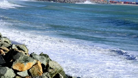 Coastal landscape with waves and container port of Genoa Voltri in the backg Stock Footage 293354315