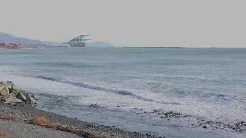 Coastal landscape with waves and container port of Genoa Voltri in the backg Stock Footage 293355714