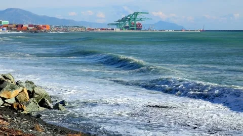 Coastal landscape with waves and container port of Genoa Voltri in the backg Stock Footage 293355717