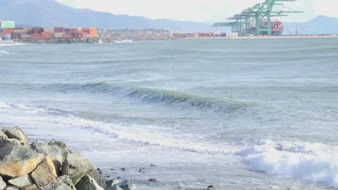 Coastal landscape with waves and container port of Genoa Voltri in the backg Stock Footage 293355718