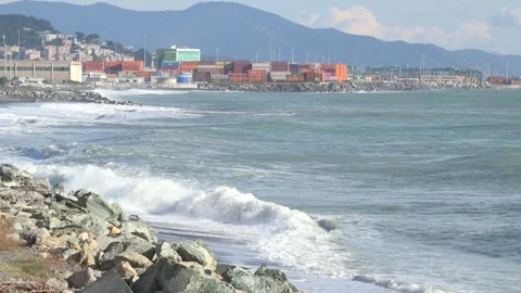 Coastal landscape with waves and container port of Genoa Voltri in the backg Stock Footage 293361256