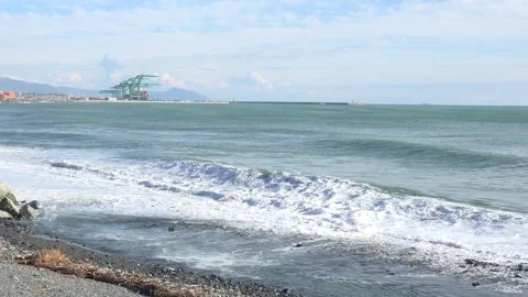 Coastal landscape with waves and container port of Genoa Voltri in the backg Stock Footage 293362807