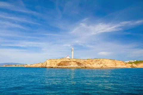Coastal ledge with lighthouse Stock Photos