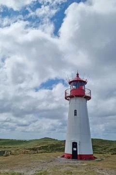 Coastal Lighthouse Against Dramatic Cloudy Sky for Nautical Design and Scener Stock Photos