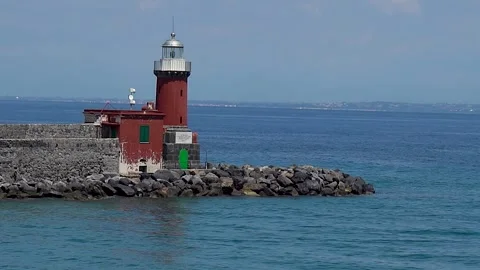 Coastal Lighthouse at Sunset – Beacon of Safety by the Sea Stock Footage 310271986