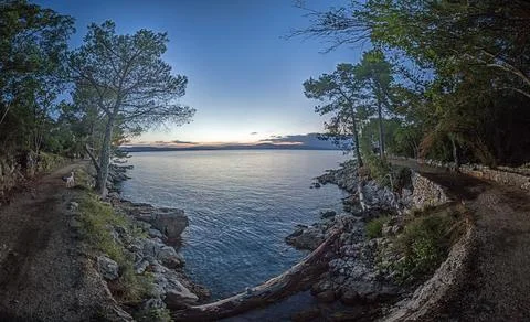 Coastal path with stone wall at sunset in Malinska Krk Stock-Fotos