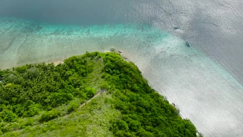 Coastal peninsula surrounded by calm turquoise waters. Logbon Island, Romblon Stock Footage 301943082