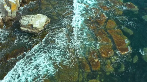 Coastal pitfalls visible through a running sea wave. Stock Footage 129701444