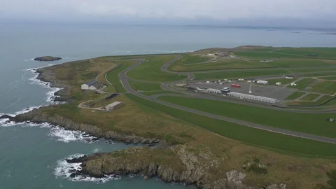 Coastal racetrack circuit overview with single car driving, drone aerial 4K Stock Footage 101114300