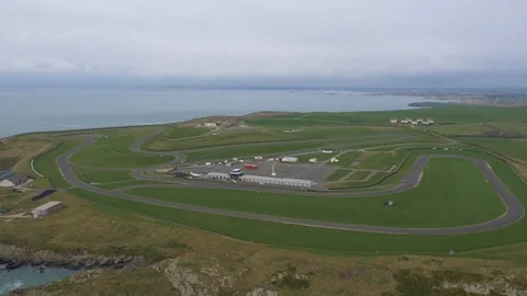 Coastal racetrack circuit overview, surrounded by land and sea, drone aerial 4K Stock Footage 101114138