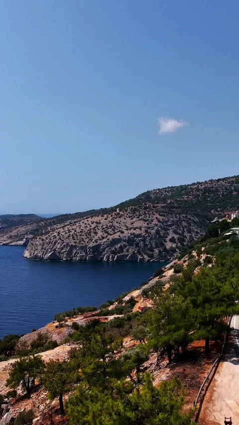 Coastal road above steep cliffs, south Thassos, vertical Stock Footage 347178673