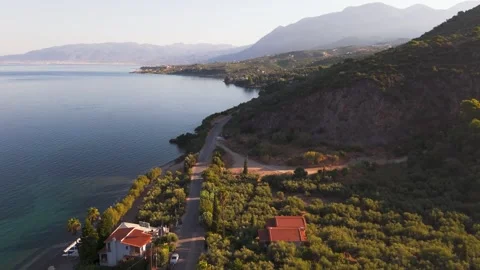 Coastal Road Beneath Rocky Cliffs, Greece Stock Footage 344049191
