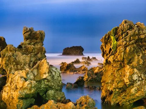 Coastal Rock Formations at Nightfall - Dramatic and mysterious long exposur.. Stock Photos
