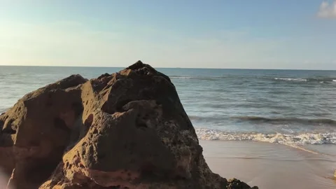 Coastal Rock on Sandy Beach with Ocean Waves at Sunrise Video stock 340489599