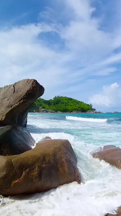 Coastal rocks and ocean waves under blue sky. Seychelles, Mahe. Stock Footage 311212821