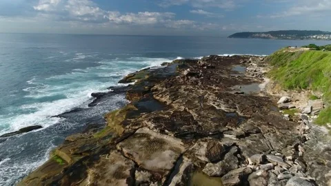 Coastal rocks and wave aerials Stock Footage 76325697