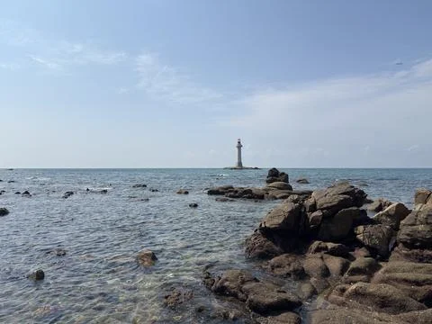 Coastal Rocks Foreground with Distant Lighthouse Stock Photos