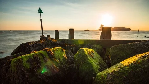 Coastal rocks timelapse with passing ship Stock Footage 76916236