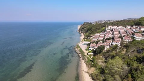 Coastal Serenity: Waves, Cliffs Homes Stock Footage 308078968