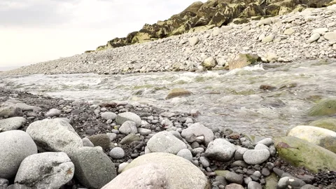 Coastal Stream Flowing Through Rocky Beach Video stock 311656295