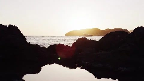 Coastal Sunset Mirrored in Tide Pool Between Cliffs, Golden Hour, Static Shot Stock Footage 340341661