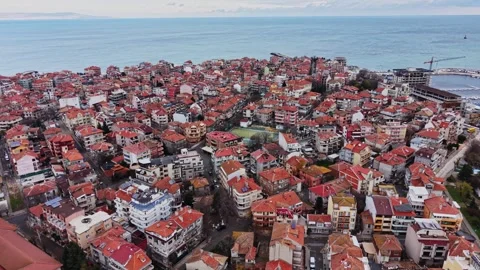 Coastal town view with orange rooftops and sea in background 스톡 동영상 332212596
