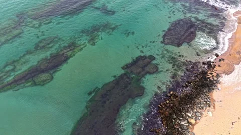 Coastal view captures rocky formations and clear waters at low tide Stock Footage 327143523