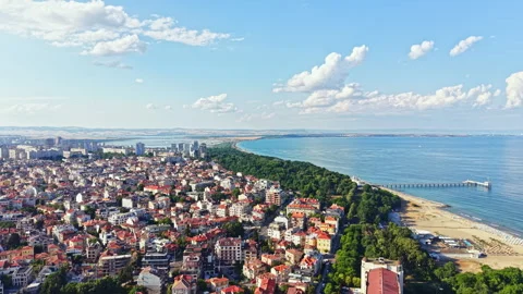 Coastal view with city layout and beach along the waterfront during a sunny day Stock Footage 340855959