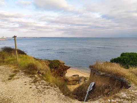 A coastal view from a cliff edge overlooking the ocean with nobody in sight.  Stock Photos