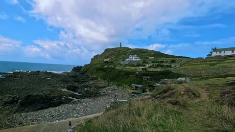 Coastal View with Lighthouse and Rocky Shore at Cape Cornwall Stock Footage 288128175